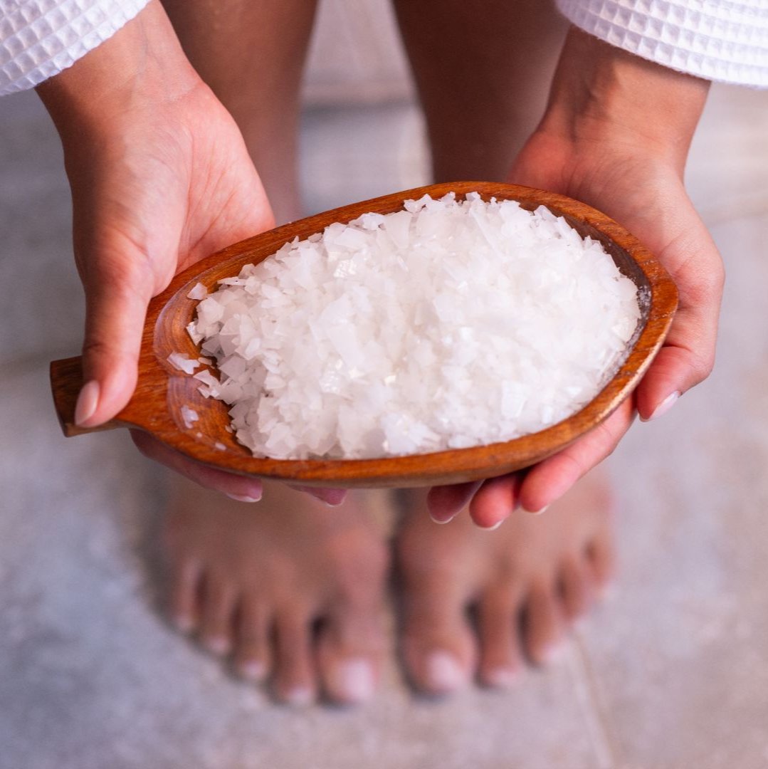 Pure magnesium flakes in hands preparing for foot bath