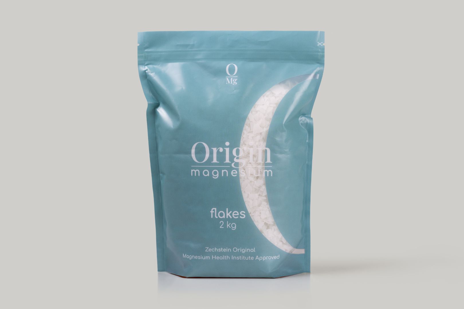 Origin OMG Magnesium Flakes, 2 kg package pack shot on a white background in a blue pouch