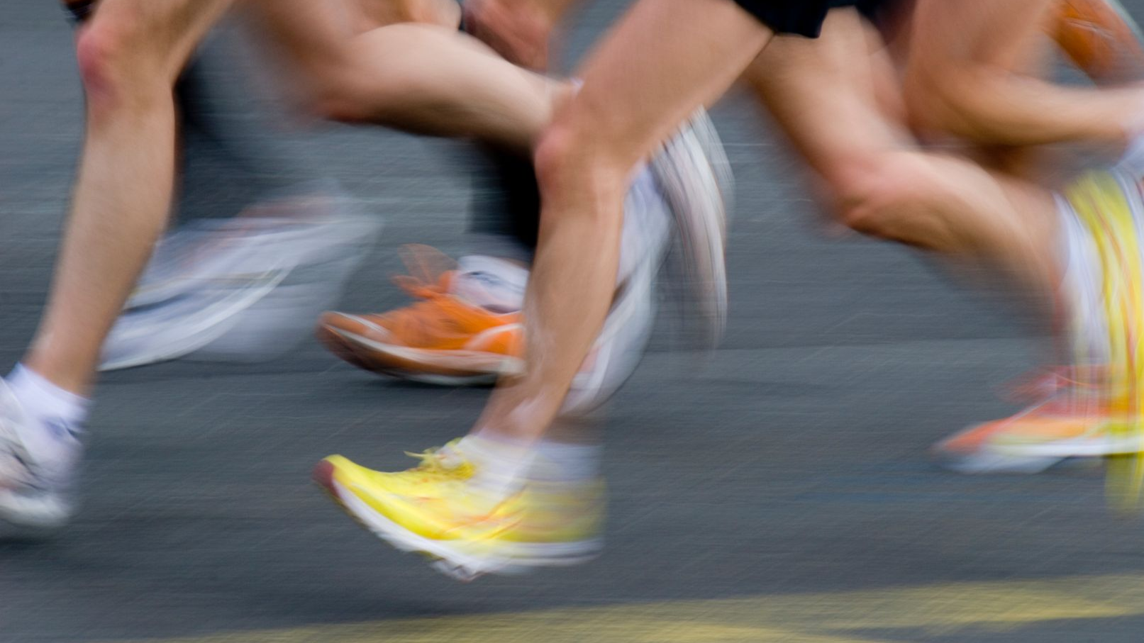 Fast running people on tarmac